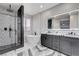 Modern bathroom with a sleek shower, soaking tub, double sinks, and vanity at 108 Parker Ranch Dr, Henderson, NV 89012