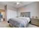 Serene bedroom with ceiling fan, sliding closet doors, and a queen bed with matching nightstands at 108 Parker Ranch Dr, Henderson, NV 89012
