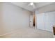 Neutral bedroom with standard closet, ceiling fan, and doorway to the hallway on soft carpet at 108 Parker Ranch Dr, Henderson, NV 89012
