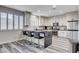 Modern kitchen featuring stainless steel appliances, a large island, and sleek countertops at 108 Parker Ranch Dr, Henderson, NV 89012
