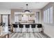 Stylish kitchen with a breakfast bar, modern lighting, and views into the formal dining area at 108 Parker Ranch Dr, Henderson, NV 89012
