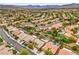 Community aerial view showcases desert landscaping, residential homes, and scenic mountain views blending urban and nature at 161 Swale Ln, Las Vegas, NV 89144