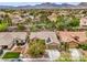 Bird's-eye view of home showcases desert landscaping, solar panels, and mountain views, blending sustainability with scenic beauty at 161 Swale Ln, Las Vegas, NV 89144
