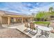 Inviting backyard patio features ample seating, desert landscaping, and partial covered space for outdoor relaxation at 161 Swale Ln, Las Vegas, NV 89144