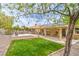 Lush backyard with a covered patio providing an ideal outdoor living space at 161 Swale Ln, Las Vegas, NV 89144