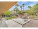 Backyard patio features lush desert landscaping and tiered hardscape for outdoor entertaining and privacy at 161 Swale Ln, Las Vegas, NV 89144