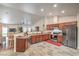 Spacious open kitchen with stainless steel appliances, granite countertops, and breakfast bar seating at 161 Swale Ln, Las Vegas, NV 89144