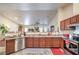 Bright kitchen featuring stainless steel appliances, wood cabinets, and a view into the living area at 161 Swale Ln, Las Vegas, NV 89144