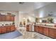 Open-concept kitchen with stainless steel appliances, wood cabinets, and seamless flow to the living area at 161 Swale Ln, Las Vegas, NV 89144