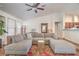Bright living area featuring a large sectional sofa, hardwood floors, and an open layout with high ceilings at 161 Swale Ln, Las Vegas, NV 89144