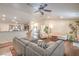 Open-concept living space featuring hardwood floors, a large sectional, and an inviting connection to the kitchen at 161 Swale Ln, Las Vegas, NV 89144