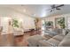 Bright living room with hardwood floors, neutral furniture, and sliding glass doors to the backyard at 161 Swale Ln, Las Vegas, NV 89144