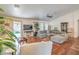 Spacious living room with hardwood floors, neutral color palette, ample seating, and sliding glass door at 161 Swale Ln, Las Vegas, NV 89144