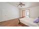 Comfortable main bedroom with neutral tones, wood floors, ceiling fan, and sliding door access to the backyard at 161 Swale Ln, Las Vegas, NV 89144