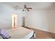 Comfortable main bedroom with neutral tones, wood floors, ceiling fan, and a closet with ample storage at 161 Swale Ln, Las Vegas, NV 89144