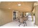 Covered patio with sliding glass door and ample seating offers comfortable outdoor dining and relaxation at 161 Swale Ln, Las Vegas, NV 89144