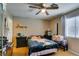 Bedroom with ceiling fan, laminate wood flooring, and a window providing natural light at 1949 King Hill St, Las Vegas, NV 89106