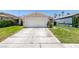 Single-story home featuring a two car garage and neatly maintained lawn with a classic suburban design at 1949 King Hill St, Las Vegas, NV 89106