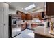 Well-lit kitchen featuring stainless steel appliances, granite countertops, and ample cabinet space at 1949 King Hill St, Las Vegas, NV 89106