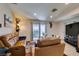 Spacious living room featuring tile flooring, neutral walls, sliding door access to the backyard and backyard access at 1949 King Hill St, Las Vegas, NV 89106