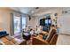 Inviting living room with tile floors, a large TV, and sliding door to the outdoor space at 1949 King Hill St, Las Vegas, NV 89106