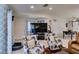 Comfortable living room featuring two floral armchairs, a large TV, and adjacent dining area at 1949 King Hill St, Las Vegas, NV 89106