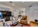 Bright living room with an open layout connecting to the dining area and a large television at 1949 King Hill St, Las Vegas, NV 89106