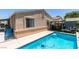 Backyard featuring a refreshing pool, lounge seating, and a covered patio area at 1949 King Hill St, Las Vegas, NV 89106
