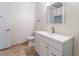 A bathroom showcasing a white single sink vanity and a toilet on neutral tile flooring at 2141 Hussium Hills St # 108, Las Vegas, NV 89108