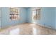 Bedroom filled with neutral tile and large windows with security bars at 2141 Hussium Hills St # 108, Las Vegas, NV 89108