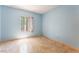 Empty bedroom featuring light blue walls, tile floors, and a window with blinds at 2141 Hussium Hills St # 108, Las Vegas, NV 89108