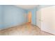 A bright bedroom with blue walls, tile flooring, and access to a closet and bathroom at 2141 Hussium Hills St # 108, Las Vegas, NV 89108