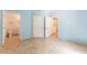 Bedroom showing bathroom access and large closet, with tile floors and blue walls at 2141 Hussium Hills St # 108, Las Vegas, NV 89108