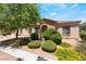 Charming single-story home with well-maintained landscaping, mature tree and desert flora in front yard at 2141 Hussium Hills St # 108, Las Vegas, NV 89108