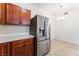Kitchen view showcasing stainless steel refrigerator and adjacent dining area with chandelier at 2141 Hussium Hills St # 108, Las Vegas, NV 89108