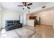 Spacious open floor plan with tile flooring, ceiling fan, and kitchen with stainless steel appliances at 2141 Hussium Hills St # 108, Las Vegas, NV 89108
