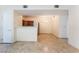 Open-concept living space with tile flooring, modern appliances, and access to the dining area at 2141 Hussium Hills St # 108, Las Vegas, NV 89108