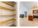 Walk-in pantry with wooden shelves; kitchen and living room visible in background at 2141 Hussium Hills St # 108, Las Vegas, NV 89108