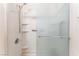 Detail of the shower featuring updated fixtures, built-in shelving and frosted glass at 2141 Hussium Hills St # 108, Las Vegas, NV 89108