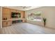 Bright living room with custom wall unit, modern fireplace, and large window overlooking landscaped yard at 2561 Terrytown Ave, Henderson, NV 89052