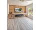 Bright living room with custom wall unit, modern fireplace, and large window offering lots of natural light at 2561 Terrytown Ave, Henderson, NV 89052