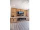 Bright living room featuring a custom wall unit with a fireplace, cabinets, and large television screen at 2561 Terrytown Ave, Henderson, NV 89052