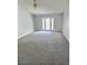 Bright living room features a neutral palette, plush carpeting, ceiling fan and French doors leading to the backyard at 3619 Edinburgh Dr, Las Vegas, NV 89103