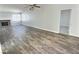 Bright living room with wood-look floors, a brick fireplace, ceiling fan, a vaulted ceiling, and a doorway at 3619 Edinburgh Dr, Las Vegas, NV 89103