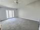 Bright and airy living room featuring plush carpeting, ceiling fan and French doors at 3619 Edinburgh Dr, Las Vegas, NV 89103