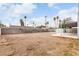 Expansive backyard with a storage shed, patio cover, and block wall, ready for landscaping at 4416 Rip Van Winkle Ln, Las Vegas, NV 89102
