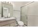 Bright bathroom featuring a vanity with a marble countertop and a sliding glass shower door at 4416 Rip Van Winkle Ln, Las Vegas, NV 89102