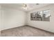 Spacious bedroom with neutral carpet, bright natural light, and ceiling fan at 4416 Rip Van Winkle Ln, Las Vegas, NV 89102