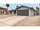 Charming single-story home featuring a two-car garage, arched windows, and low-maintenance gravel landscaping at 4416 Rip Van Winkle Ln, Las Vegas, NV 89102