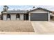 Charming single-story home with gray stucco, gravel landscaping, solar panels, and attached two-car garage at 4416 Rip Van Winkle Ln, Las Vegas, NV 89102